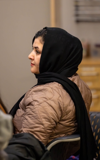 Employers Resources Woman intently listening to a speaker for newcomers to Red Deer.